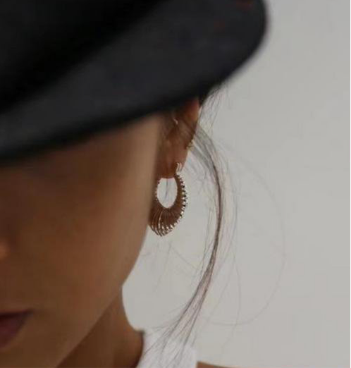 Patterned earrings with minimalist fluid design