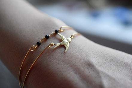 Eleganter vergoldeter Armreif mit fliegender Schwalbe